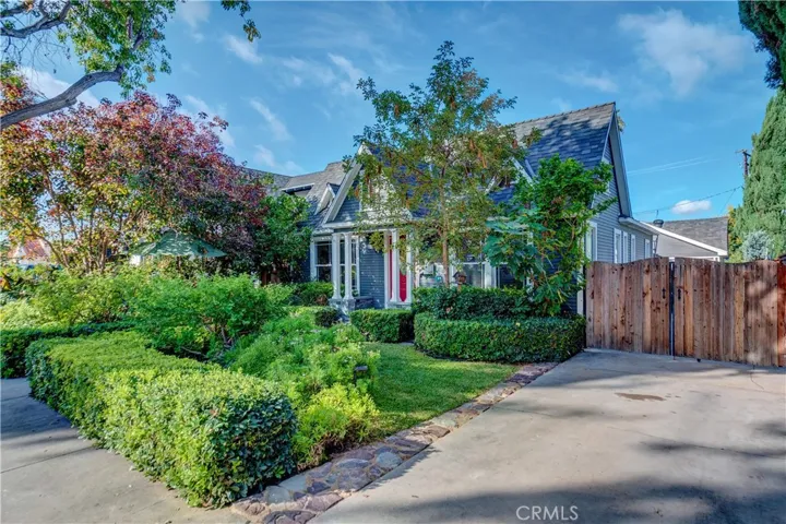 Beautifully landscaped yards, a long driveway with an oversized, detached 2 car garage and secure gates