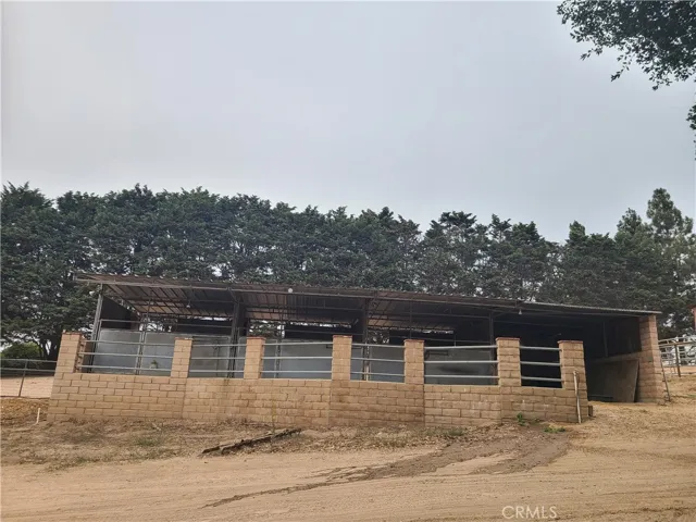 Three covered horse stalls with separate covered storage area