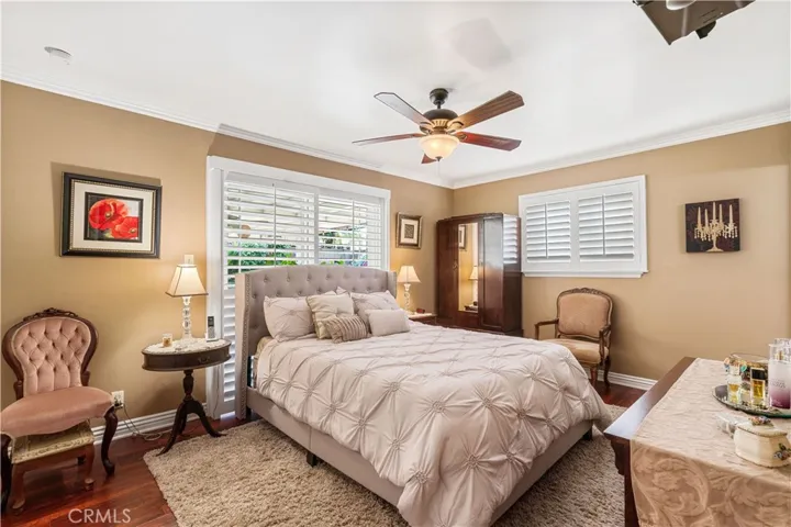 MASTER BEDROOM WITH DOUBLE DOORS LEADING TO COVERED PATIO
