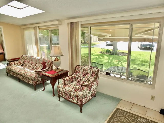 Spacious living room has two skylights and large dual pane windows