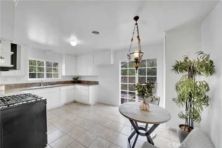 Roomy kitchen with eat in breakfast area, slider doors to the extra wide side yard.