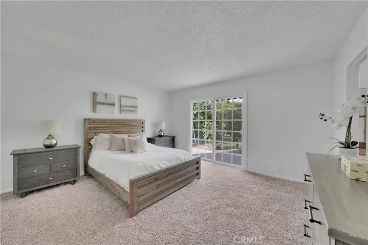 Downstairs master bedroom with slider doors to the private backyard.
