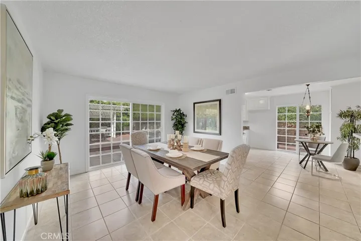 Extra large dining room or make it a family room, has slider doors to the private backyard.