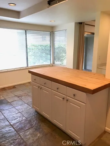 Kitchen Island with butcher block counter. Looking into eat in area