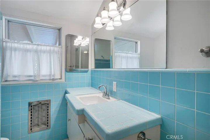 Bathroom off the Kitchen with tile walls and counter