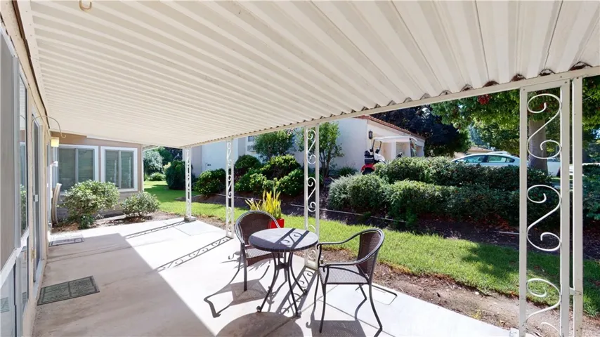 Morning sun drenched patio has room for comfortable seating area and an outdoor dining table.