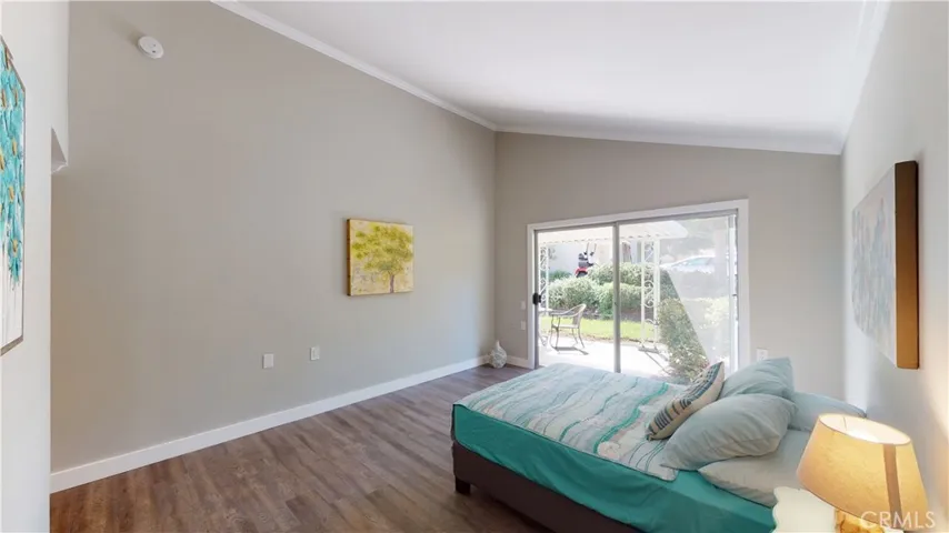 Master bedroom with vaulted ceiling and  crown molding.