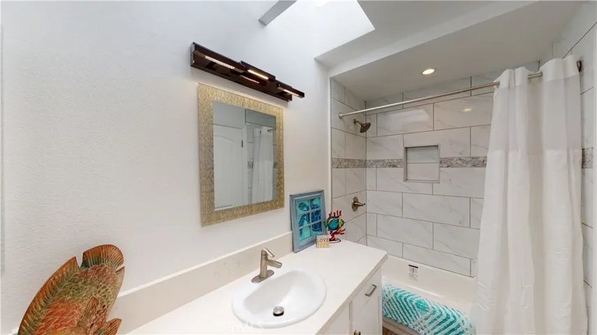 Guest and 2nd bedroom bath with all new fixtures, finishes, tub & tile, new exhaust fan and LED lighting fixtures.