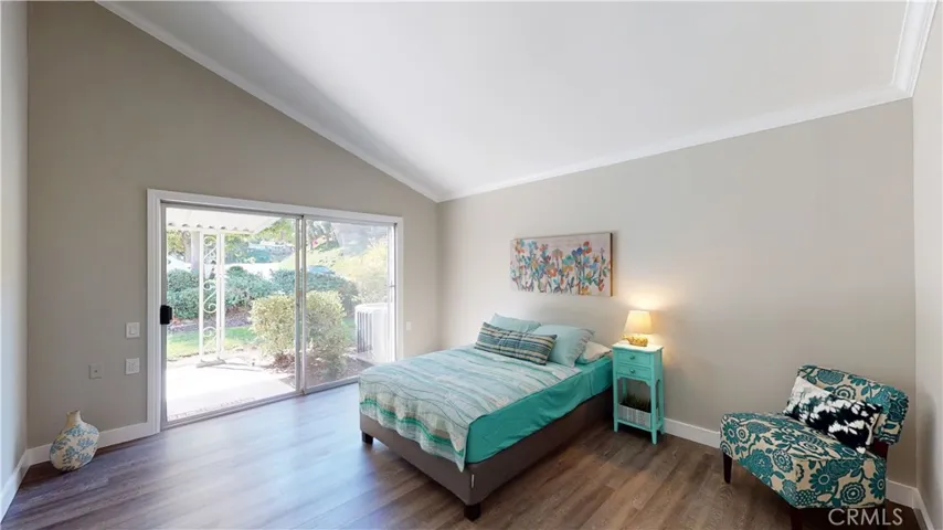Brightly flooded with natural light in the Master bedroom with  slider to covered patio.