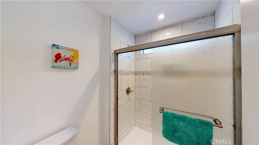 Complete new shower tile, base, rain glass enclosure with LED recessed light and new exhaust fan.