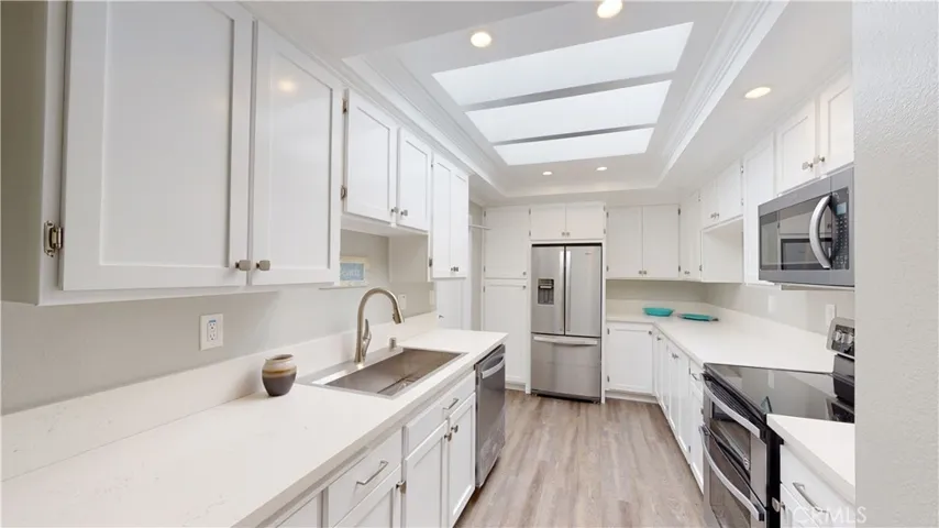 Expanded and updated kitchen with more quartz countertop for food prep and cooking area.