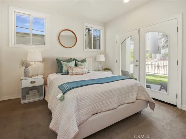 bedroom 3 with private bath and private french doors overlooking grassy yard