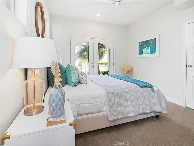 bedroom 3 with private bath and private french doors overlooking grassy yard