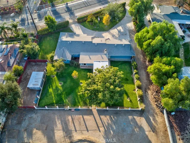 Aerial view rear of home and gated grass area
