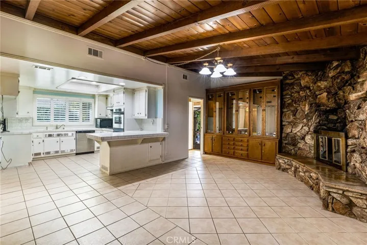 Open kitchen to family room with cozy, stone fireplace