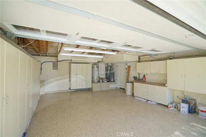 Two car garage with epoxy, cabinets and AC