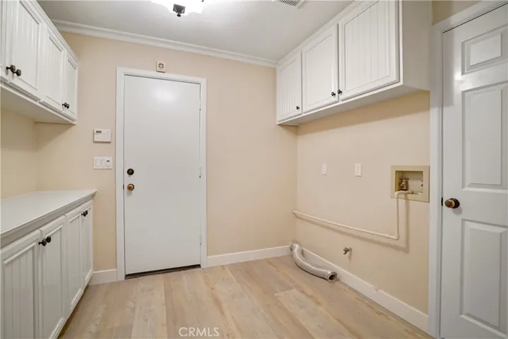 Interior laundry room leading to the garage