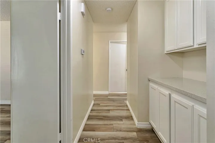 Hall with cabinets and granite top