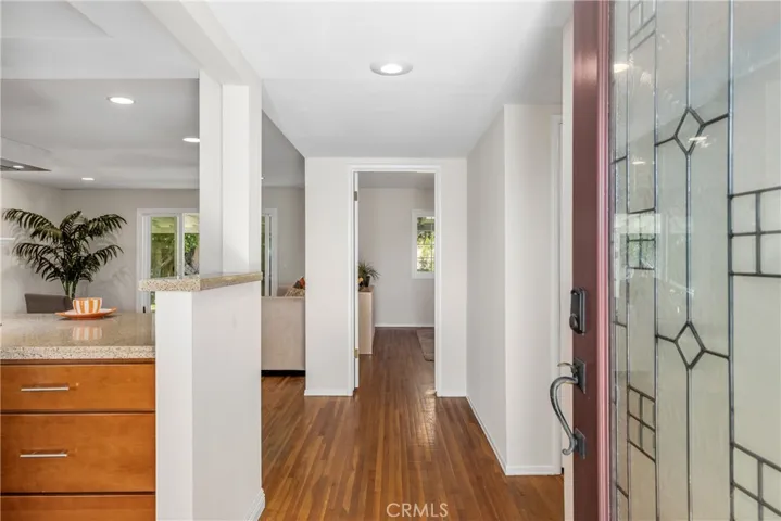 The foyer features the kitchen on the left, and looks straight through to the yard.