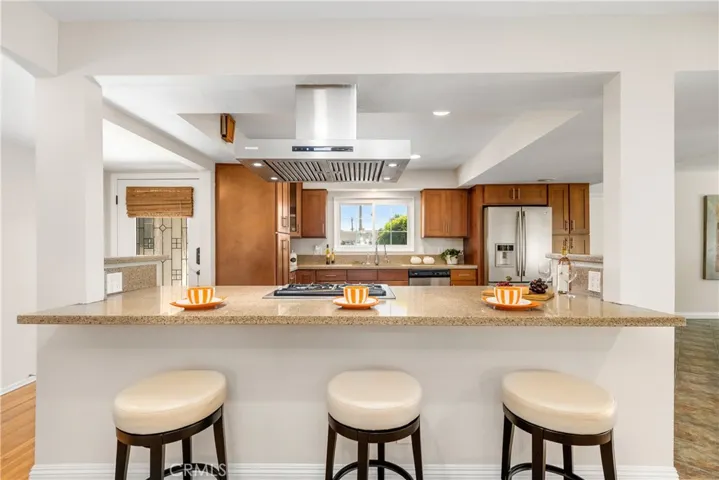 A reverse view looking from the living room towards the large, open contemporary kitchen.