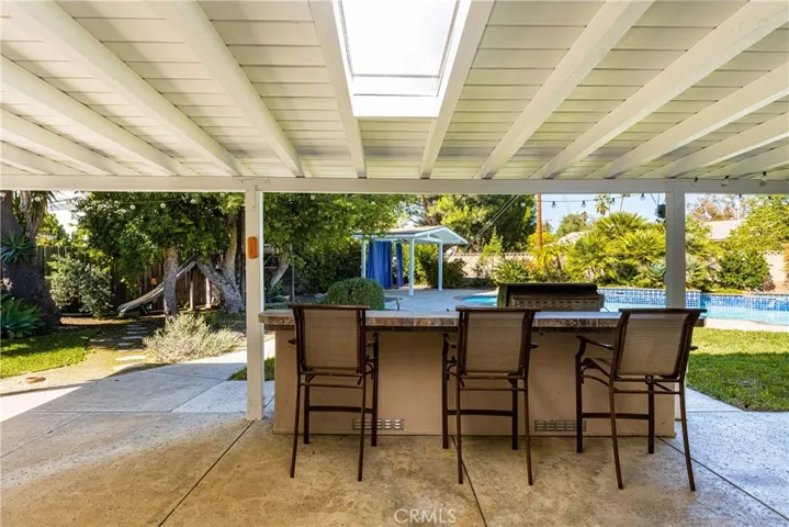 The covered patio feature skylights and a built-in BBQ with bar.