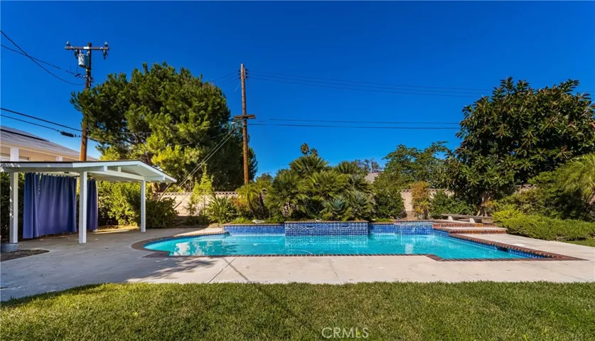 The Gazebo next to the pool features privacy curtains.