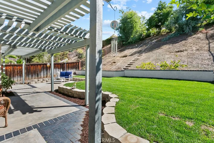 Another view of your lush rear yard & patio area.
