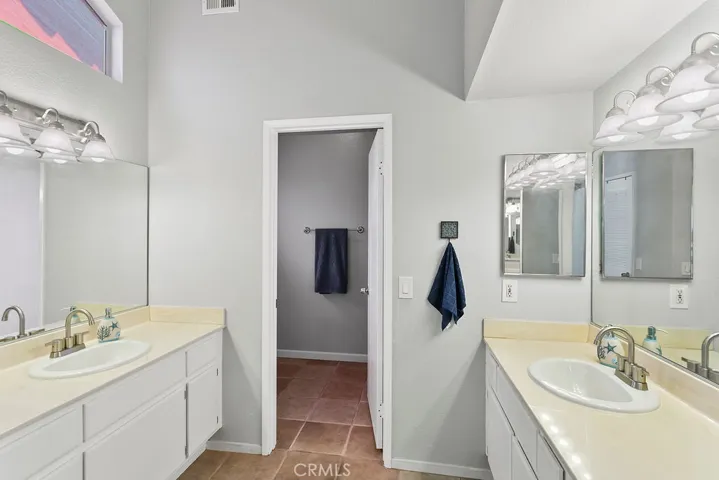 Primary Bedroom En Suite Bathroom area, his & her vanity area with separate room with Full bath Shower/Tub combo & toilet area.