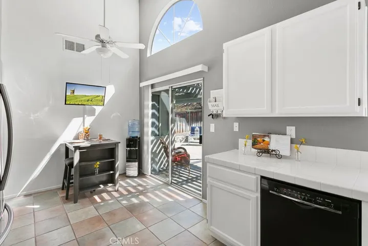Light, bright & clean Kitchen with Kitchenette area, sliding glass door leading to rear patio yard. Vaulted ceiling, tile flooring, pantry & ceiling fan.