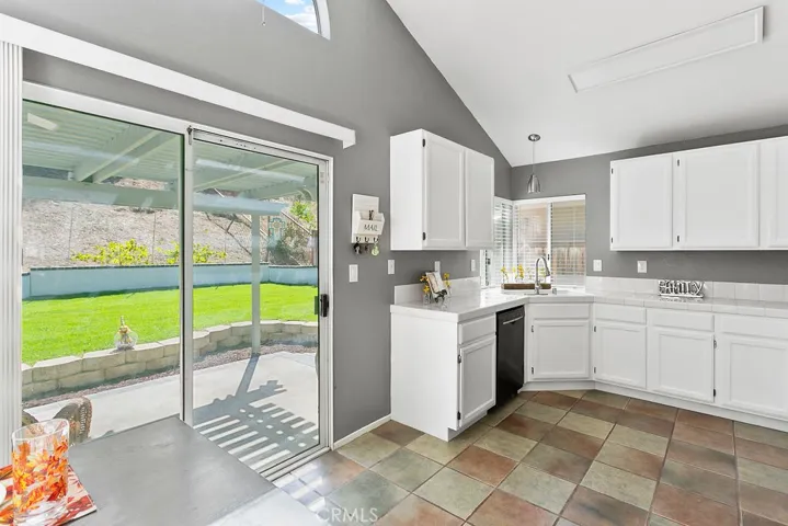Corner view of your kitchen & views of your rear yard.