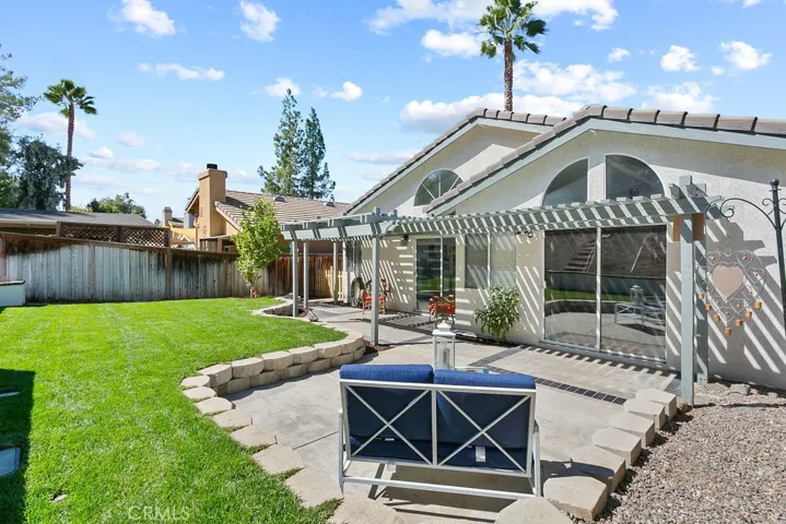 View of rear patio & glass sliding doors from primary bedroom & kitchen.