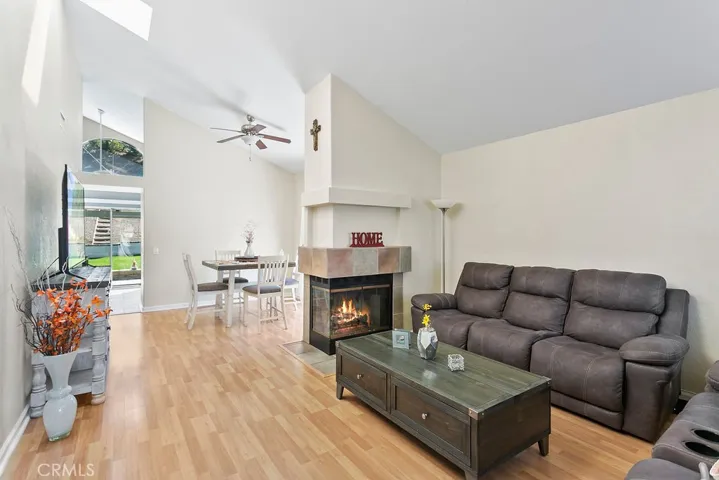 Home sweet home, vaulted ceiling in the living room with fireplace & formal dining area with ceiling fan.