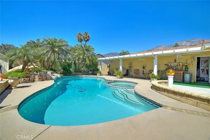 Completely covered patio with lights and fans over looking pool