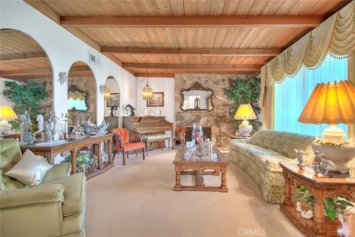 Spacious living room with a gas fireplace and beautiful wood beams