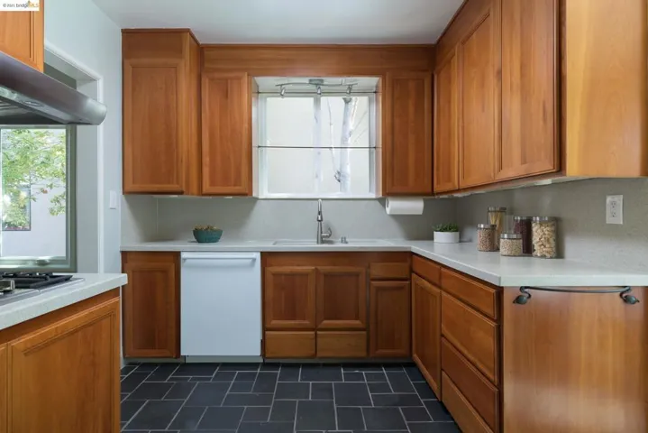 Corian counters, warm wood modern cabinetry, wall mount oven and gas cook top.