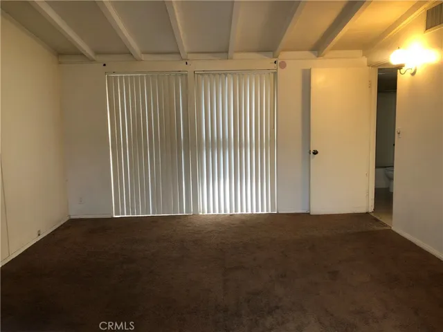 Master bedroom has large windows opening to the courtyard.