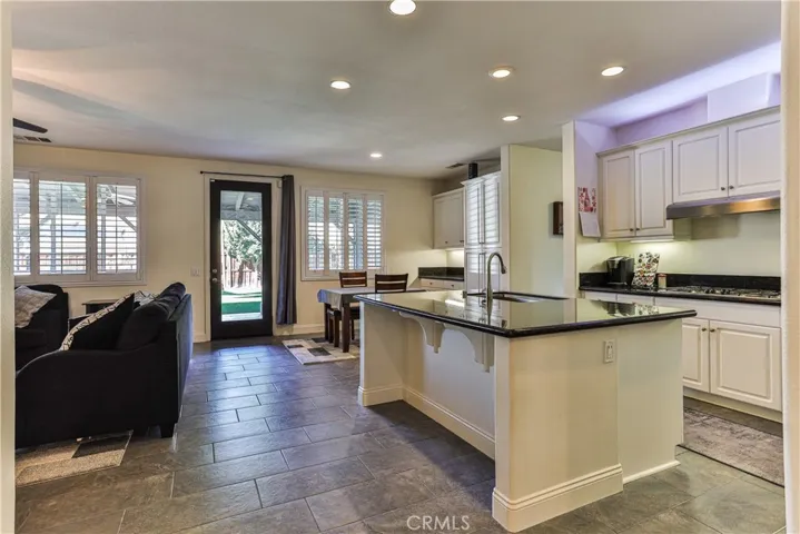 Open plan kitchen with island, eating nook, and family room