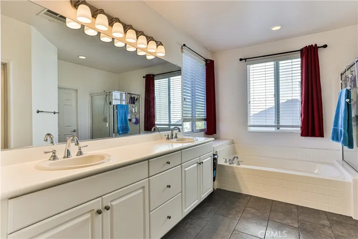 Master ensuite bath with soaker tub, dual sinks, separate shower and separate toilet behind door