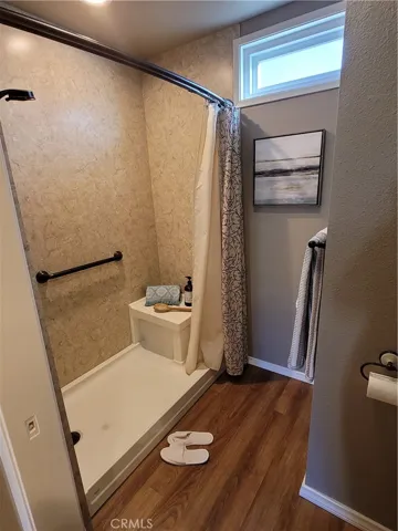 Private shower and toilet area, separate from sinks.
