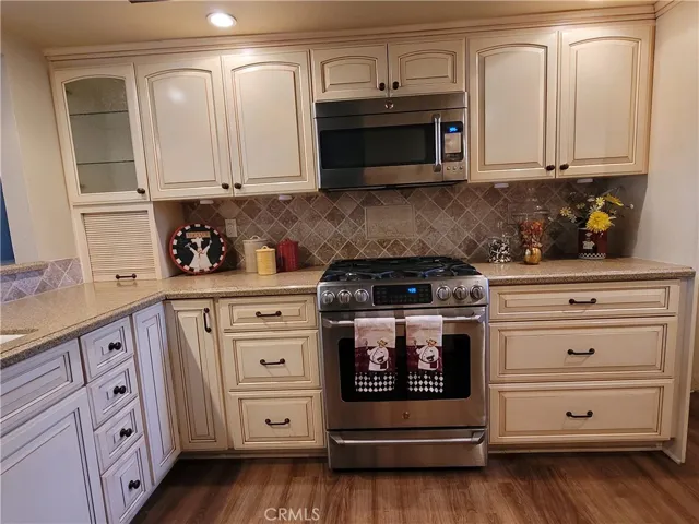 Beautiful remodeled kitchen with cabinets and quartz countertops.