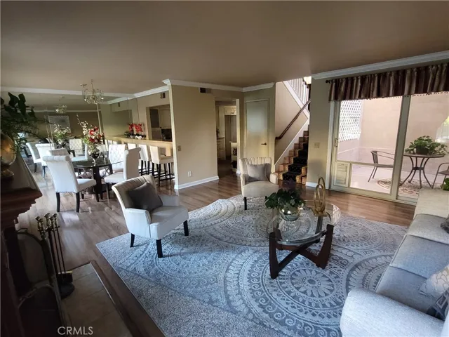 Living room with view of atrium, kitchen and dining area.