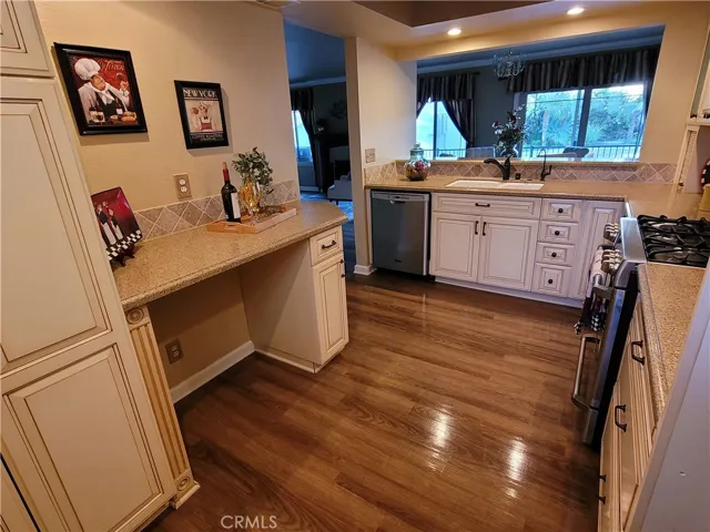 Full view of kitchen looking out to dining area and living room.