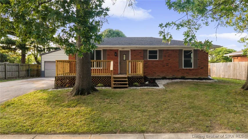 Front exterior view of the home showing the entryway and front yard.