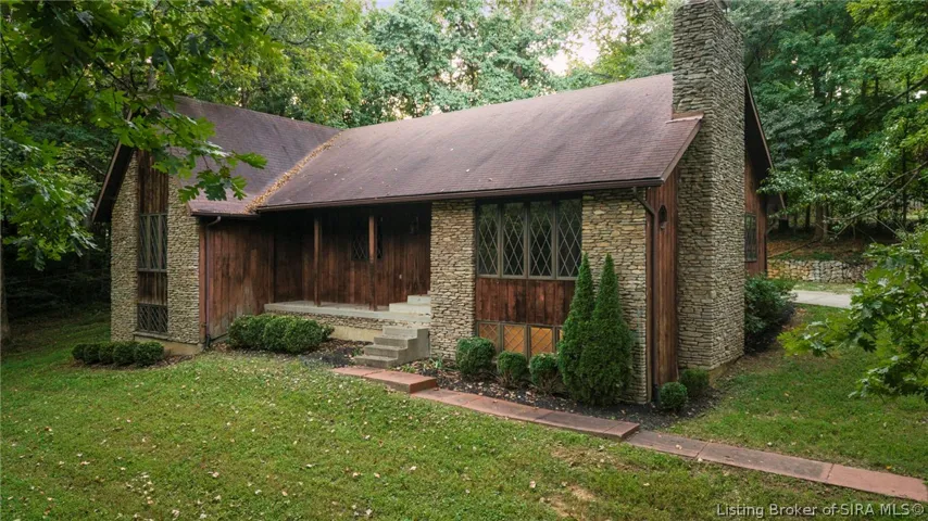 Front exterior view surrounded by mature trees and established landscaping.