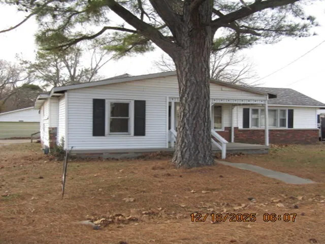 Bungalow featuring a porch and brick siding