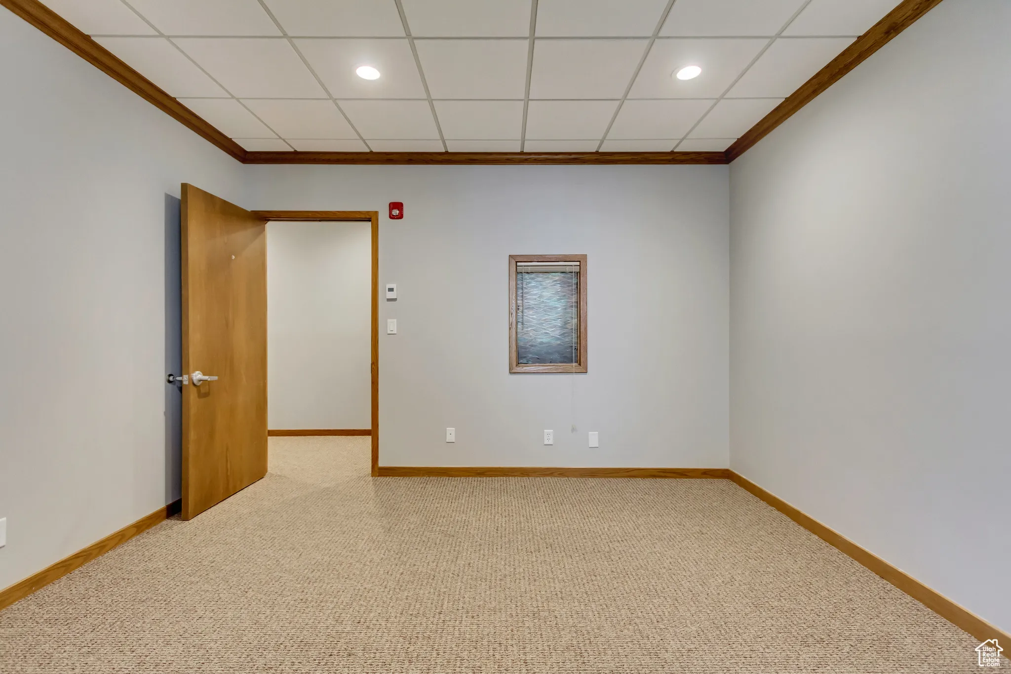 Spare room with baseboards, carpet flooring, recessed lighting, and ornamental molding