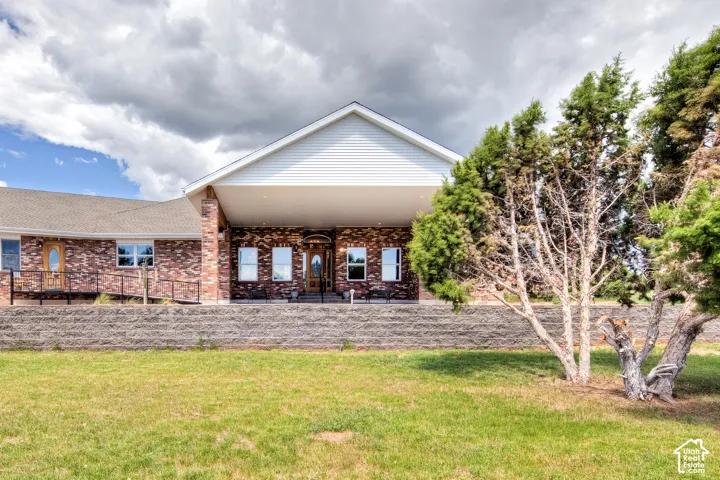 Back of property with a yard