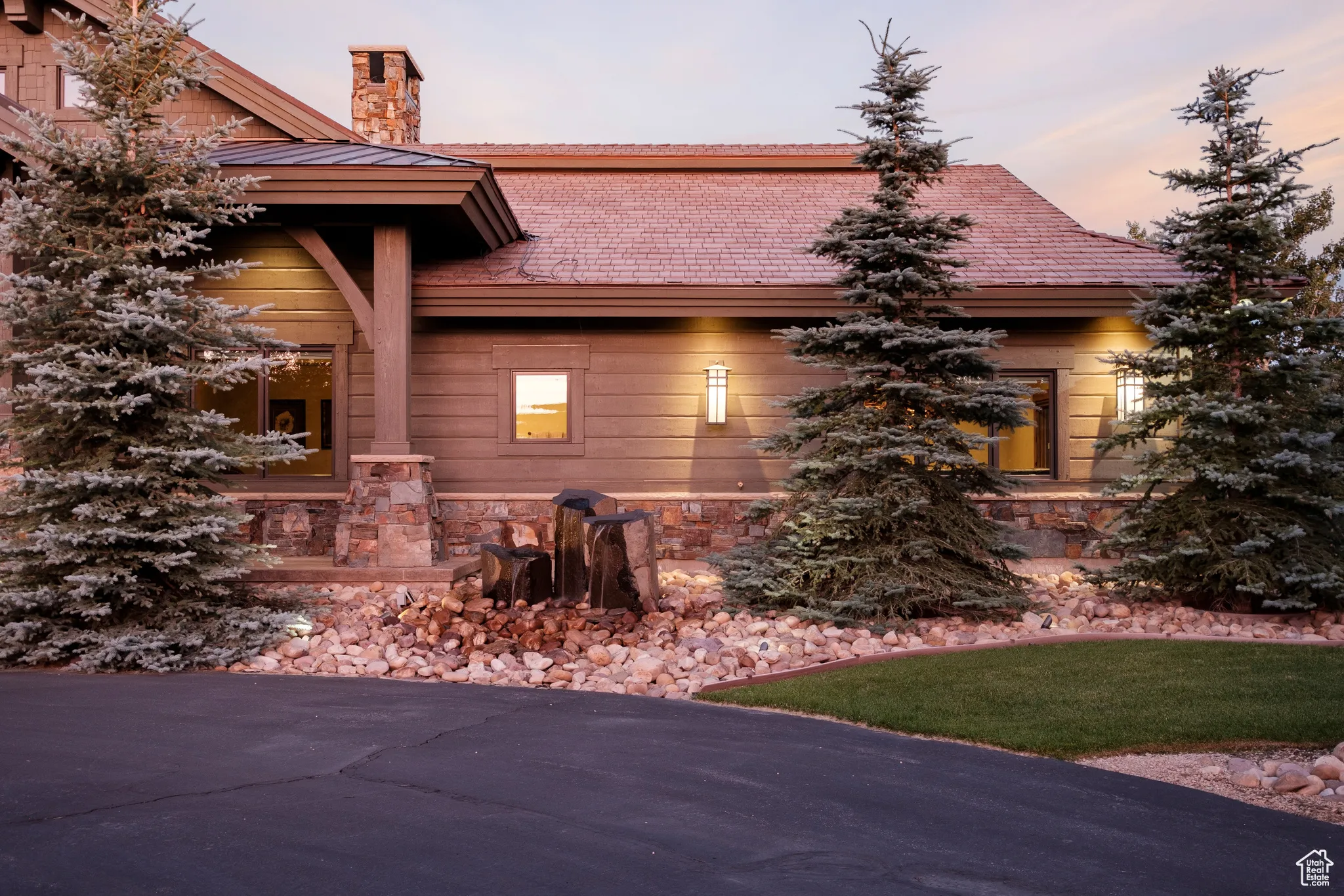 Property exterior at dusk featuring a chimney