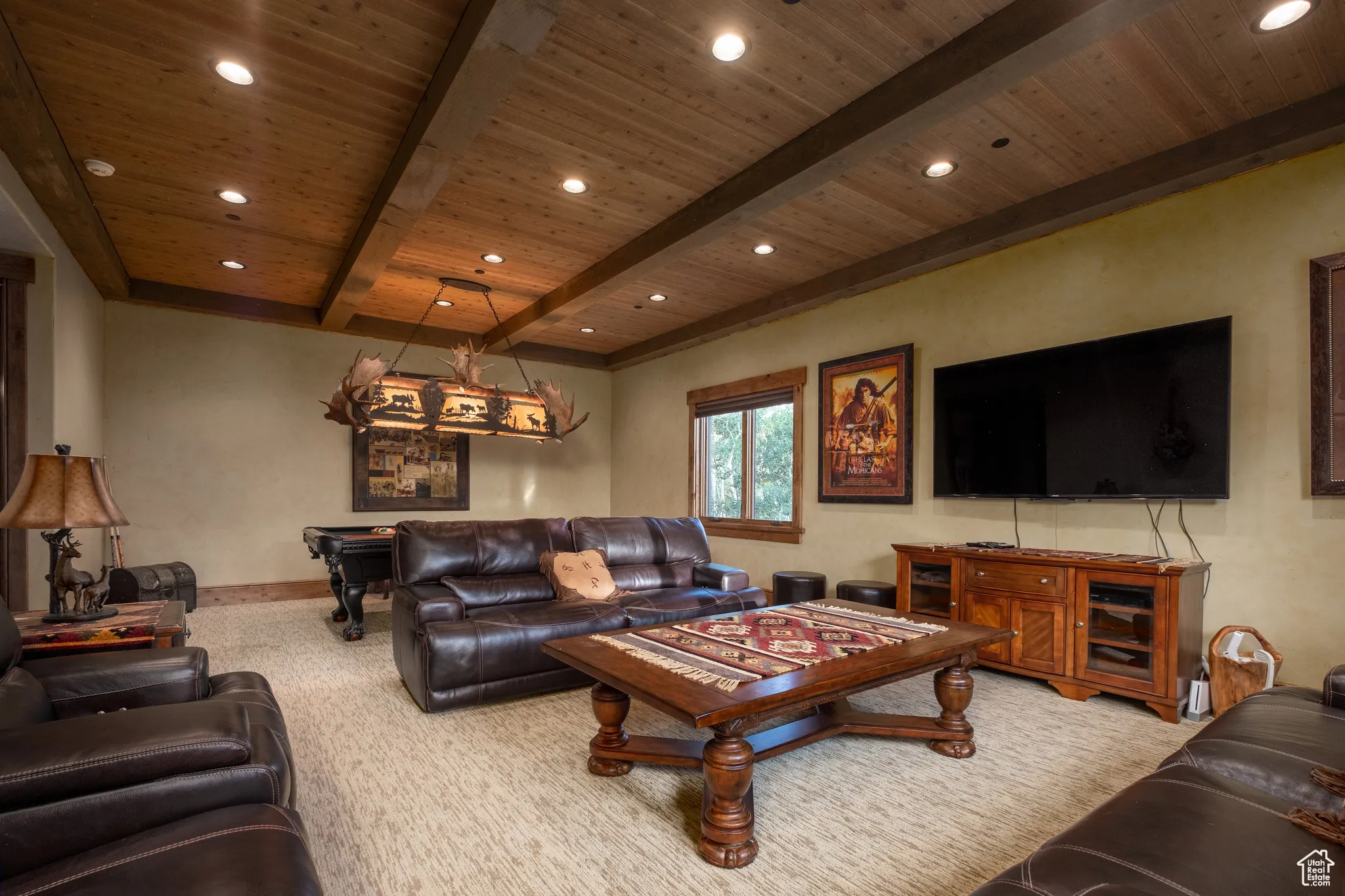 Carpeted living area with baseboards, recessed lighting, beamed ceiling, and wood ceiling
