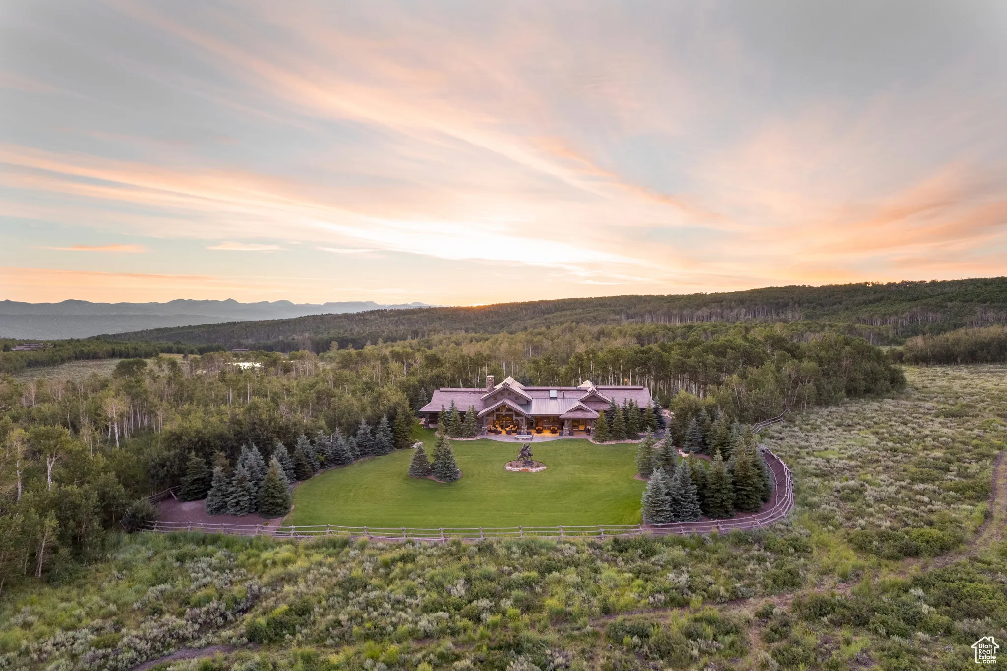 Birds eye view of property with a wooded view